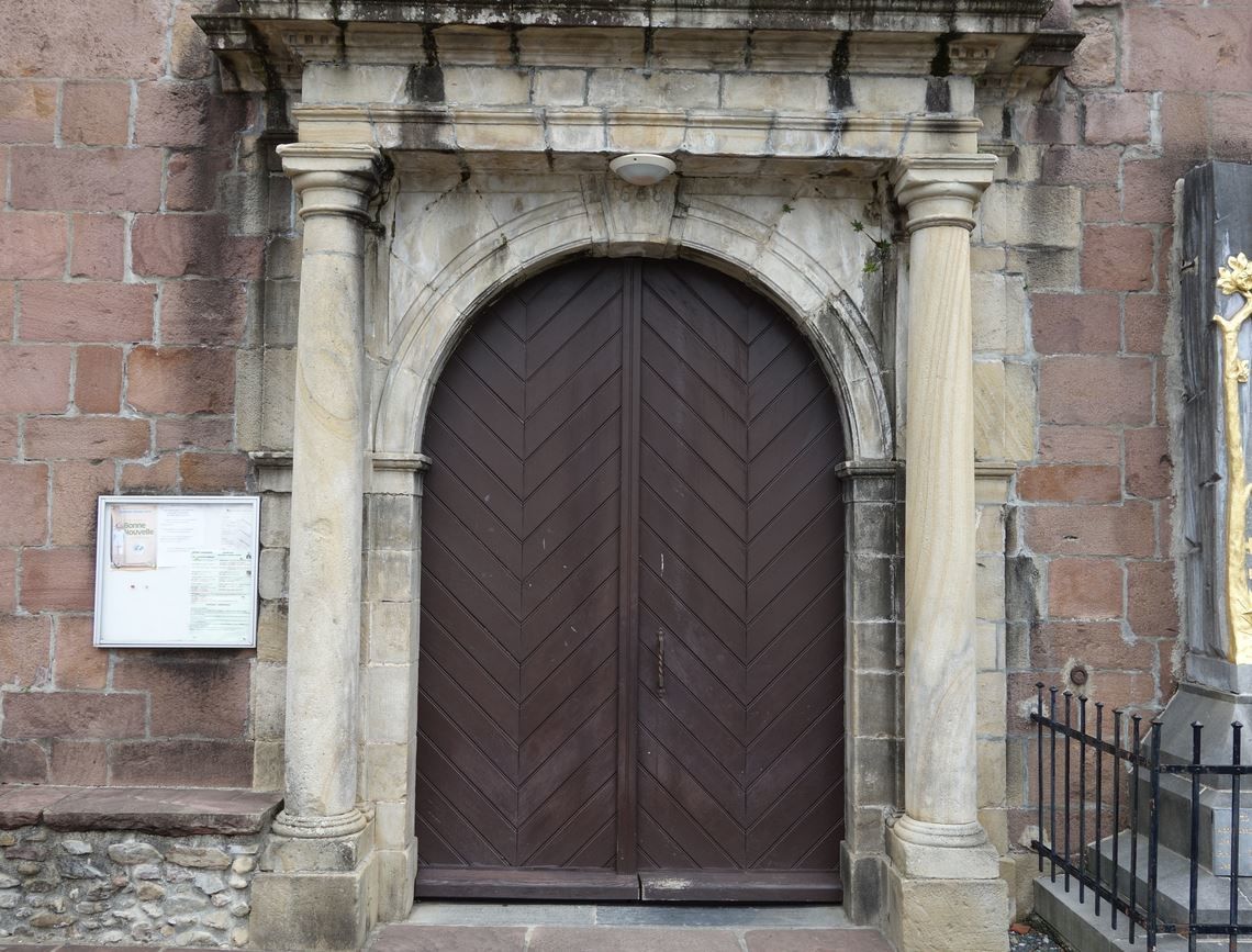 L'entrée principale est plus baroque, avec une statue de la vierge et un porche, entouré de colonnes, au dessus duquel est rappelé la date de création de l'église Saint Julien. Un monument aux morts est présent à droite de cette entrée.