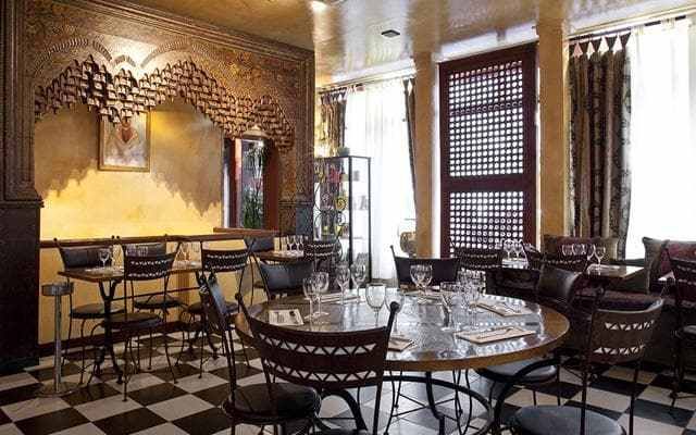 Kilims, brass trays, tiled tables and carved wooden screens set the scene for refined cooking