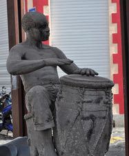 Gwoka was born in a dark period of the Guadeloupe history . It is not only a music but everything that revolves around it : the dance, games , jokes , a certain way of being, in a word, a whole way of life that comes from our African ancestors. Further down the street, A statue of Marcel Lollia called "Vélo" playing the Ka was erected in his honor. When Marcel Lollia died June 5, 1984. His death marks its entry into the History of Guadeloupe, as it becomes a reference in the Gwo Ka music.