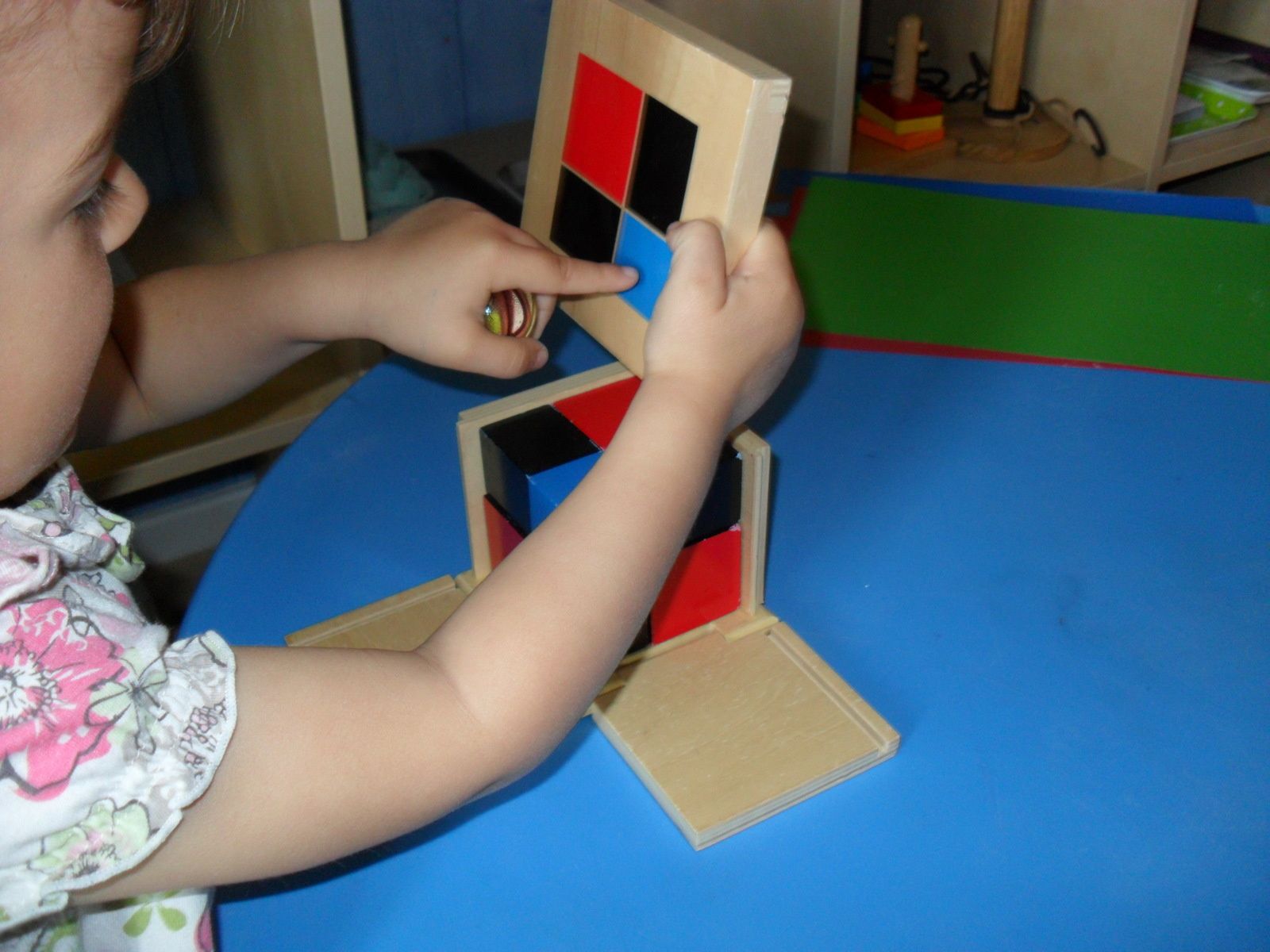 Elle se corrige en regardant les couleurs sur le couvercle du cube.