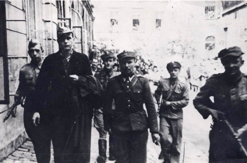 At 6 foot 4 inches tall (194 cm), Goeth towered over his Polish guards.
