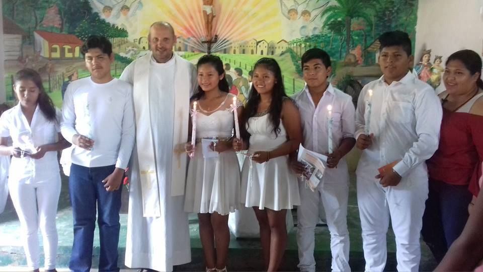 with altar servants and young men receiving the sacrament of confirmation.