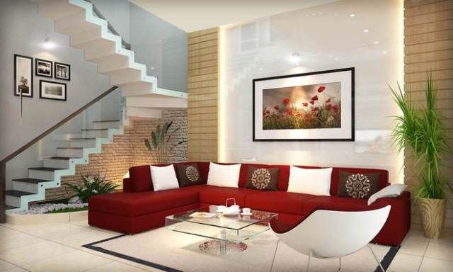 Ghế sofa màu đổ đô được đặt ở trung tâm phòng khách