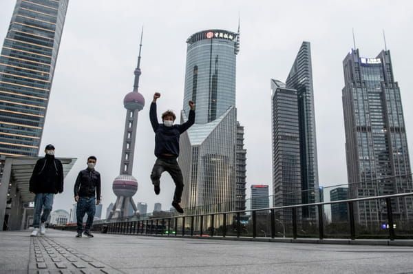 AFP Trois personnes masquées dans le quartier des affaires de Shanghai, le 8 février 2020 © AFP - NOEL CELIS