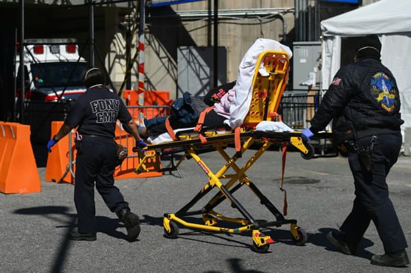 Des ambulanciers transportent un malade contaminé par le Covid-19 à l'hôpital de Brooklyn, le 27 mars 2020 New York © AFP - Angela Weiss